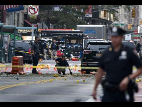 Craig Ruttle     Crime scene investigators work yesterday at the scene of Saturday's explosion in Manhattan's Chelsea neighborhood in New York