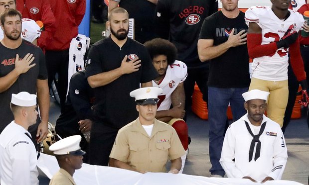 Denver LB Brandon Marshall takes a knee during anthem