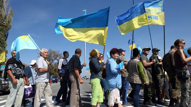 Crimean Tatars and Ukrainian activists block the road at a checkpoint between Ukraine and Crimea during a protest last year