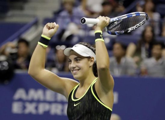 Ana Konjuh of Croatia raises her arms after