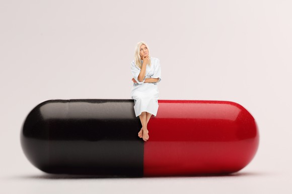 Woman Sitting On Pill Pharma