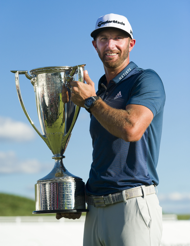 Dustin Johnson poses with his trophy after winning the BMW Championship golf tournament at Crooked Stick Golf Club in Carmel Ind. Sunday Sept. 11 2016