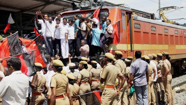 DMK members stage a rail roko in the Coimbatore railway station on Friday