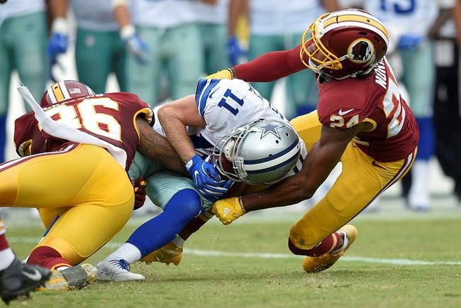 Washington Redskins defensive back Su'a Cravens and cornerback Josh Norman stop Dallas Cowboys wide receiver Cole Beasley during the second half of an NFL football game in Landover Md. Sunday Sept. 18 2016