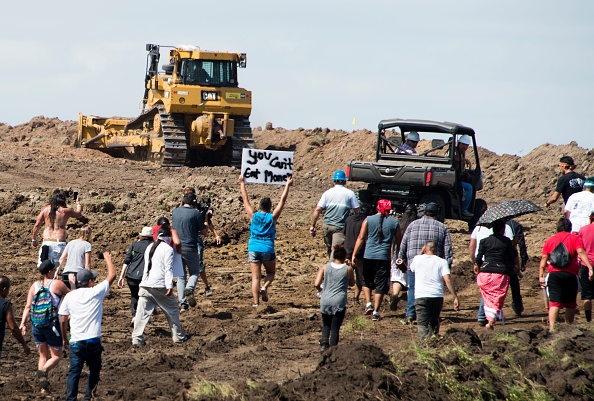 Native American protestors and their supporters are confronted by security during a demonstration against work being done for the Dakota Access Pipeline oil pipeline near Cannon Ball North Dakota