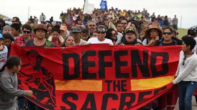 Native Americans march to a burial ground sacred site that was disturbed by bulldozers building the Dakota Access Pipeline