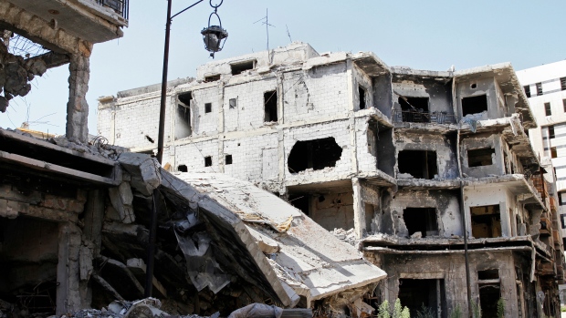 Damaged buildings and rubble line a street in Homs Syria Sept. 19 2016