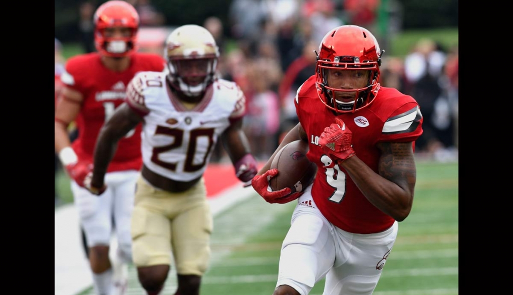 Louisville's Jaylen Smith attempts to outrun the pursuit of Florida State's Trey Marshall during the first quarter of an NCAA college football game Saturday Sep. 17 2016 in Louisville Ky