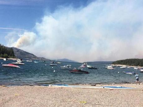 Smoke fills the sky in a view north toward Yellowstone National Park from Leeks Marina in Moose Wyo. on Tuesday