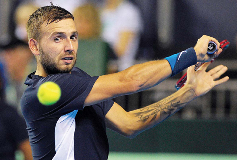 GLASGOW Britain’s Dan Evans returns to Argentina’s Leonardo Mayer during the Davis Cup World Group semi-final singles match 5 between Britain and Argentina at the Emirates Arena in Glasgow Scotland yesterday. — AFP