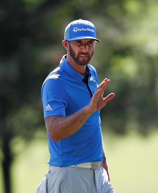 Dustin Johnson waves after making a putt for birdie on the 11th hole during the second round of play at the Tour Championship golf tournament at East Lake Golf Club Friday Sept. 23 2016 in Atlanta