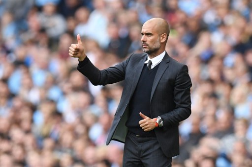 Manchester City's Spanish manager Pep Guardiola gives a thumbs up from the touchline during the English Premier League football match between Manchester City and Bournemouth at the Etihad Stadium in Manchester north west England