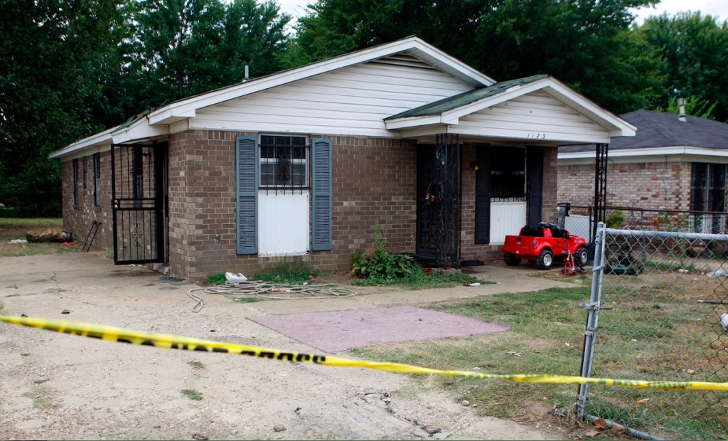 Security tape stretches across the driveway of a home where an early morning fire killed multiple people Monday Sept. 12 2016 in Memphis Tenn