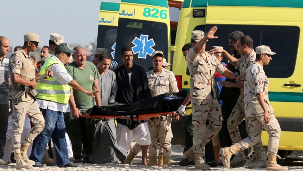 Rescue workers carry a body on a stretcher after a boat carrying migrants capsized off Egypt's coast in Al-Beheira Egypt on Wednesday