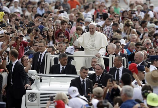 Pope Francis waves to faithful as he is driven through the crowd ahead of his weekly general audience in St. Peter's Square at the Vatican Wednesday Aug. 31 2016