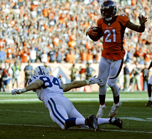 Denver Broncos cornerback Aqib Talib scores past Indianapolis Colts tight end Jack Doyle after a interception during the second half in a NFL football game Sunday Sept. 18 2016 in Denver