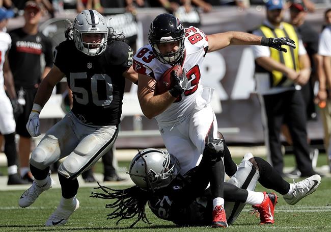 Atlanta Falcons tight end Jacob Tamme runs against Oakland Raiders middle linebacker Ben Heeney and free safety Reggie Nelson during the first half of an NFL football game in Oakland Calif. Sunday Sept. 18 2016. (AP