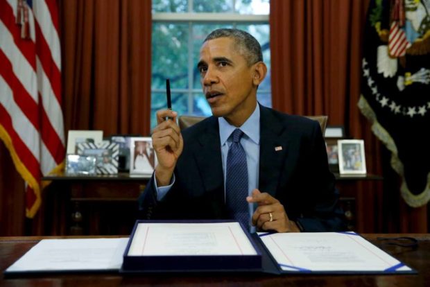 U.S. President Barack Obama speaks to reporters after signing the Bipartisan Budget Act of 2015 into law in the Oval Office at the White House in Washington