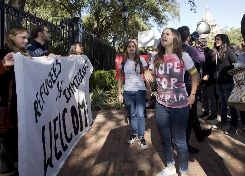 Demonstrators protest the state's actions toward blocking Syrian refugees from resettling in Texas