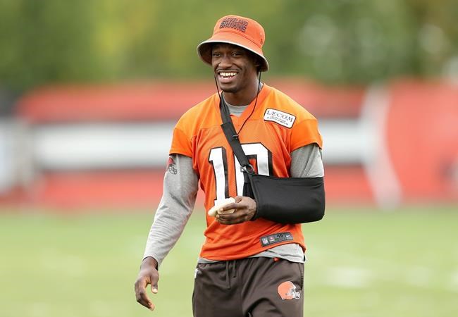 Cleveland Browns quarterback Robert Griffin III watches the teams NFL football practice with his arm in a sling Wednesday Sept. 14 2016 in Berea Ohio. Griffin III‚Äôs future is again on hold. After suffering a broken bone in his left shoulder