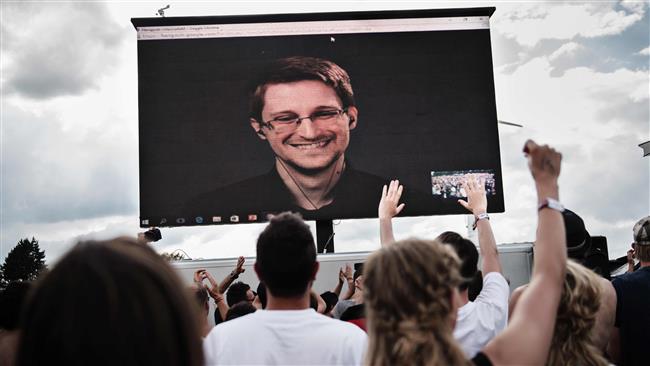 Former US intelligence contractor and whistle blower Edward Snowden can be seen on a giant screen as he is interviewed by the performance group The Yes Men live at the Roskilde Festival in Denmark