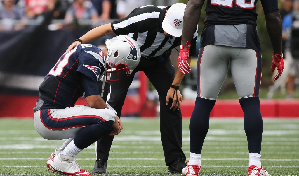 FOXBORO MA- SEPTEMBER 18 Jimmy Garoppolo #10 of the New England Patriots reacts on the field after suffering an injury during the second quarter against the Miami Dolphins at Gillette Stadium