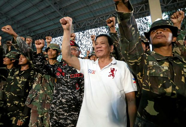 DOING IT HIS WAY President Rodrigo Duterte enjoys a show of strength with soldiers during his visit to the headquarters of the Philippine Army Scout Rangers in the town of San Miguel