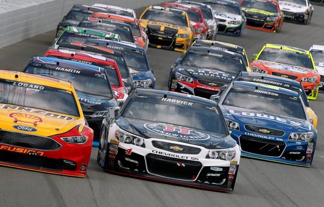 Joey Logano and Kevin Harvick battle for the lead during a NASCAR Sprint Cup Series auto race at Michigan International Speedway in Brooklyn Mich. Sunday Aug. 28 2016