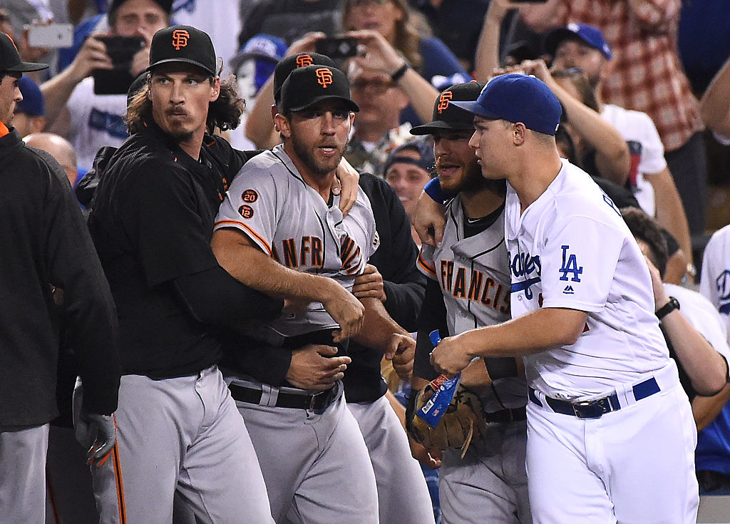 LOS ANGELES CA- SEPTEMBER 19 Jeff Samardzija #29 of the San Francisco Giants holds back Madison Bumgarner #40 of the San Francisco Giants as Joc Pederson #31 of the Los Angeles Dodgers holds back Brandon Crawford #35 of the San Francisco Giants after