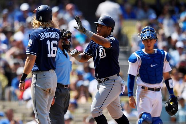 San Diego Padres&#39 Yangervis Solarte center is congratulated by Travis Jankowski left after hitting a two-run home run as Los Angeles Dodgers catcher Austin Barnes watches during the third inning of a baseball game Sunday Sept. 4 2016 in Los An