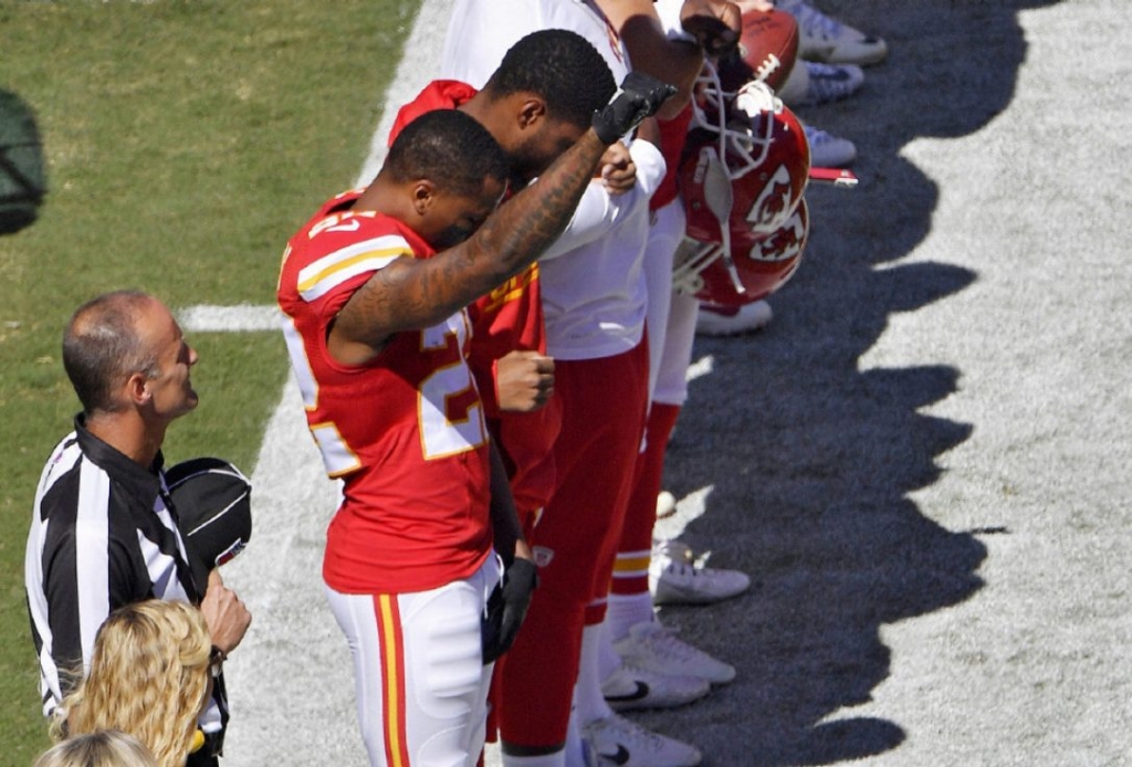 Kansas City Chiefs cornerback Marcus Peters raises his fist in the air during the national anthem prior to Sunday's game in K.C