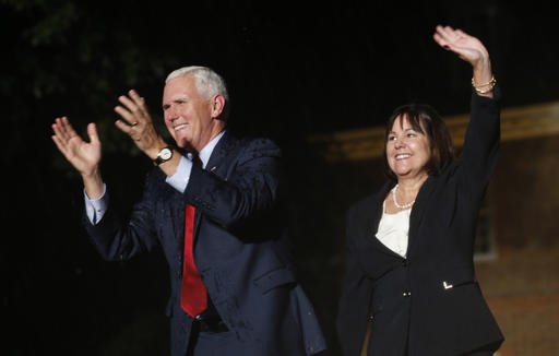 Republican vice presidential candidate Indiana Gov. Mike Pence and his wife Karen right wave to the crowd at a rally in front of the Colonial Capitol in Williamsburg Va. Tuesday Sept. 20 2016