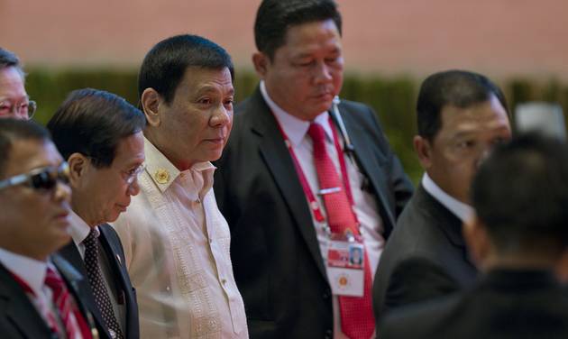 Philippine President Rodrigo Duterte third left in white top walks in with officials during ongoing 28th and 29th ASEAN Summits and other related summits at National Convention Center in Vientiane Laos Thursday Sept. 8 2016. (AP