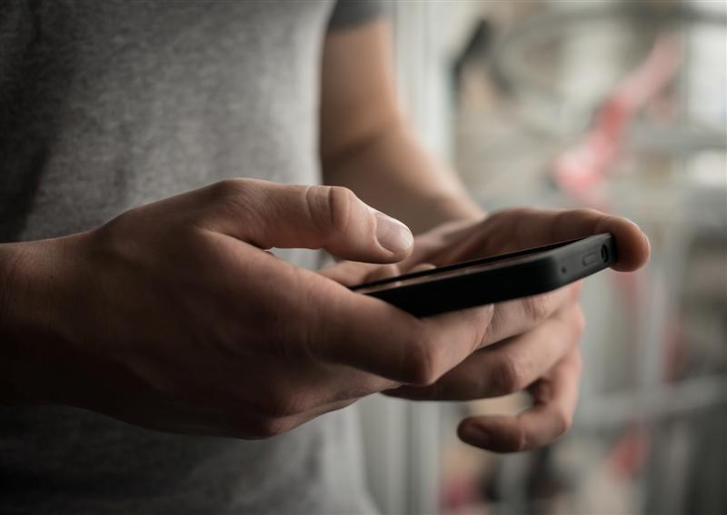 Close up of a man using mobile smart phone