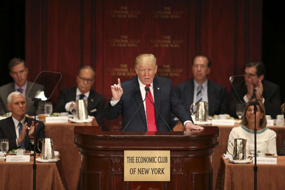 Indiana Gov. Mike Pence applauds at left as Republican presidential candidate Donald Trump unveils his economic plan at the Economic Club of New York in New York City