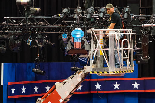 A technician examines the lighting grid as preparations continue for Monday's first debate presidential between Democratic Hillary Clinton and Republican Donald Trump Saturday Sept. 24 2016 at Hofstra University in Hempstead N.Y. (AP