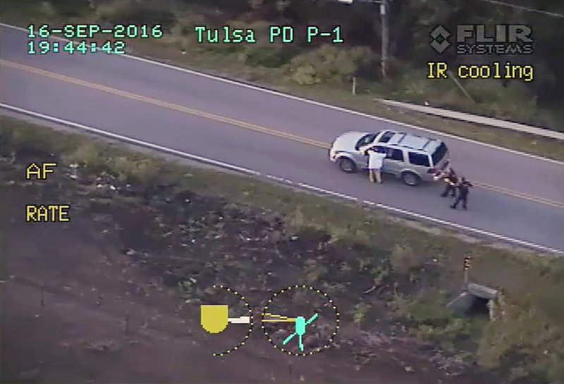 Sept. 16 2016 police video Terence Crutcher left with his arms up is pursued by police officers as he walks next to his stalled SUV moments before he was shot and killed by one of the officers in Tulsa Okla. When it comes