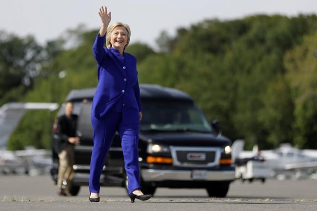 Democratic presidential candidate Hillary Clinton waves as she walks to her campaign plane at Westchester County Airport in White Plains N.Y. Wednesday Sept. 21 2016