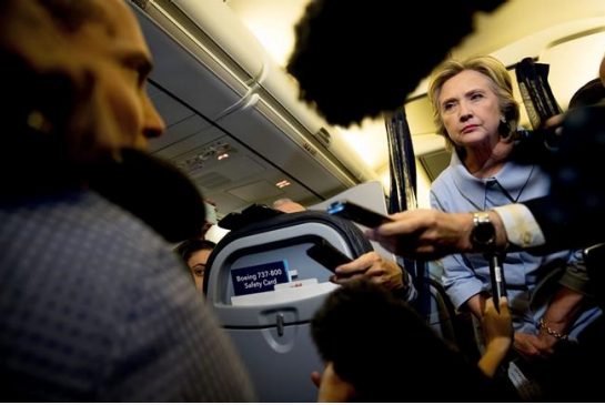 Democratic presidential candidate Hillary Clinton takes a question from a member of the media on her campaign plane while traveling to Quad Cities International Airport in Moline Ill. Monday Sept. 5 2016