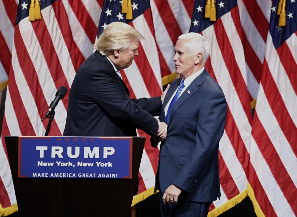 US Republican presidential nominee Donald Trump shakes hand with his vice presidential running mate Indiana Governor Mike Pence