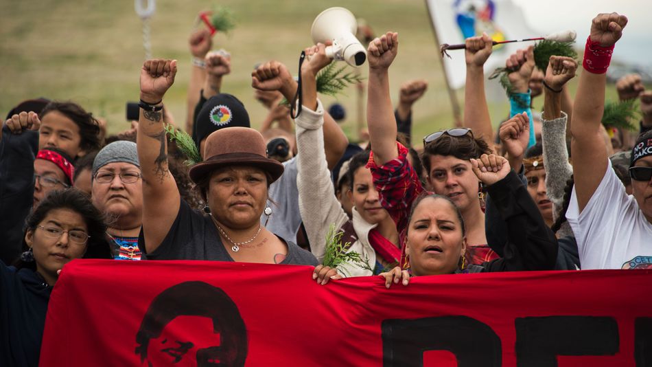 Native Americans march to a burial ground sacred site that was disturbed by bulldozers building the Dakota Access Pipeline