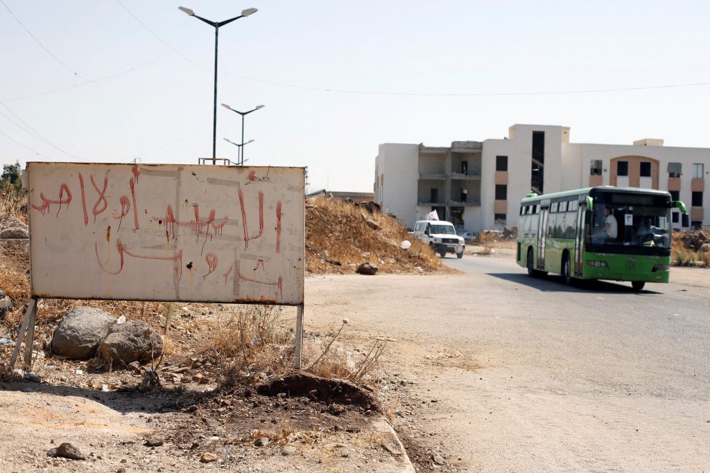 A bus with Syrian rebels and their families evacuating the besieged Waer district in the central Syrian city of Homs