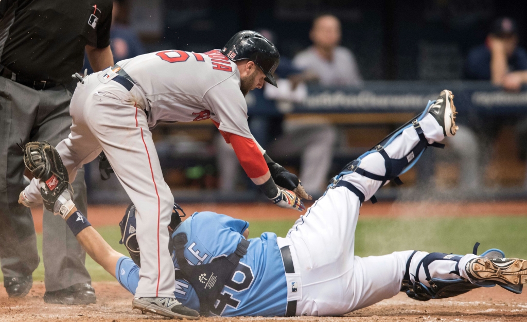 Sep 25 2016 St. Petersburg FL USA Boston Red Sox second baseman Dustin Pedroia avoids the tag of Tampa Bay Rays catcher Luke Maile to score the winning run in the tenth inning at Tropicana Field. Mandatory Credit Jeff Griffith-USA TODAY Sp