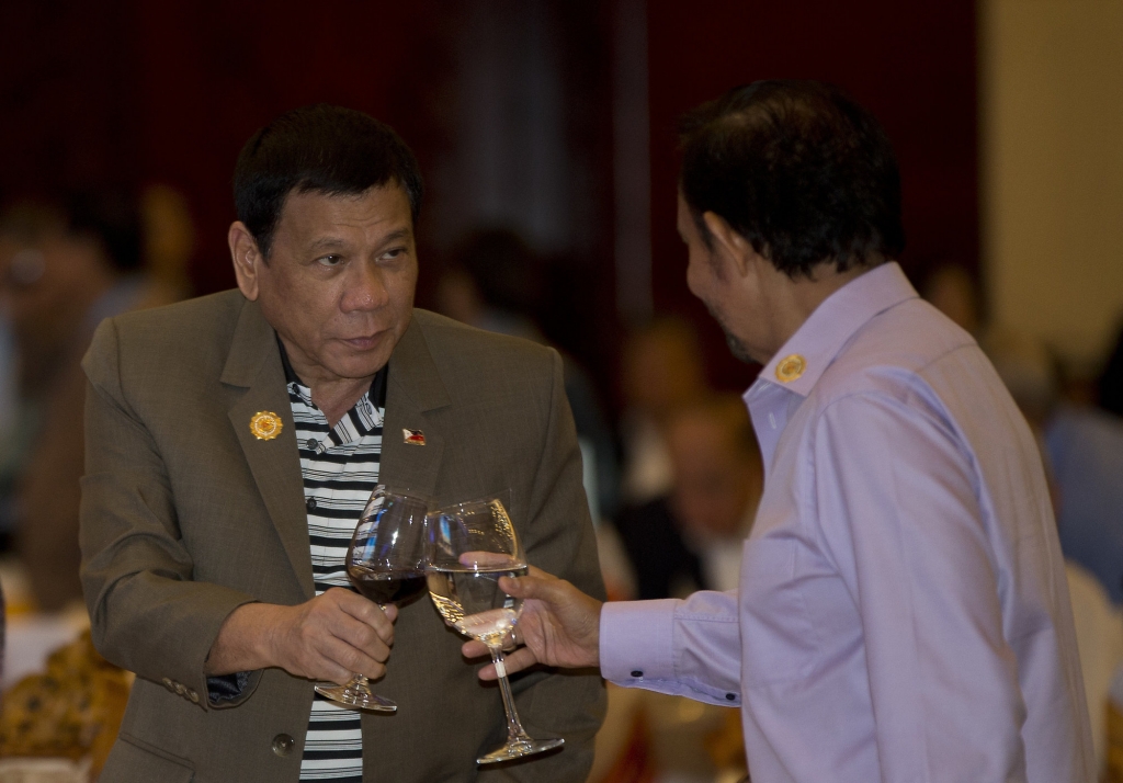 Philippine's President Rodrigo Duterte toasts a drink with Brunei Foreign Minister and Prime Minister Sultan Hassanal Bolkiah during Association of Southeast Asian Nations summit welcome dinner in Vientiane Laos Tuesday Sept. 6 2016. (AP