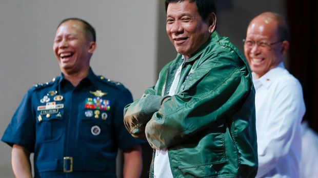 Philippines President Rodrigo Duterte wears a pilot's jacket presented to him during a visit to Air Force headquarters