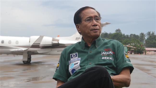 Philippine Presidential Peace Adviser Jesus Dureza sits on the tarmac shortly after arriving at the airport in Jolo town in Sulu province on the southern Philippines island of Mindanao