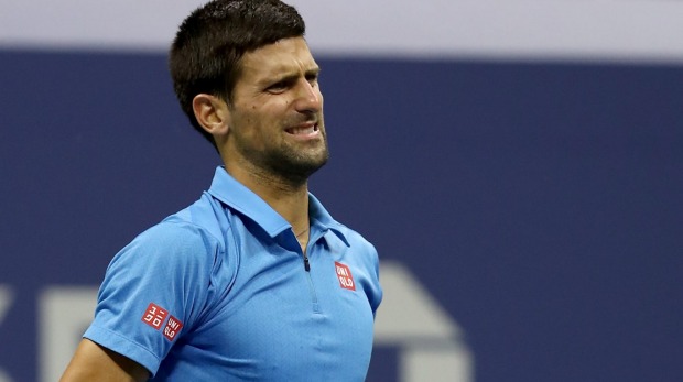 Novak Djokovic grimaces with pain during his US Open final against eventual winner Stan Wawrinka of Switzerland