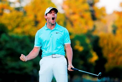 Rory Mc Ilroy of Northern Ireland celebrates a birdie putt to defeat Ryan Moore on the fourth playoff hole to win the TOUR Championship and clinch the FedExCup