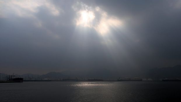 The sun shines from behind the clouds over the Fujairah port during the launch of the new $US650 million oil facility