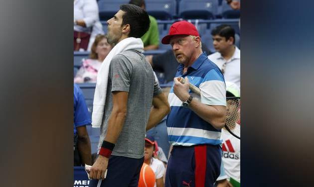 Novak Djokovic of Serbia left talks with his coach Boris Becker right during a practice session after his opponent Mikhail Youzhny of Russia retired in the first set of their match during the third round of the U.S. Open tennis tournament Friday